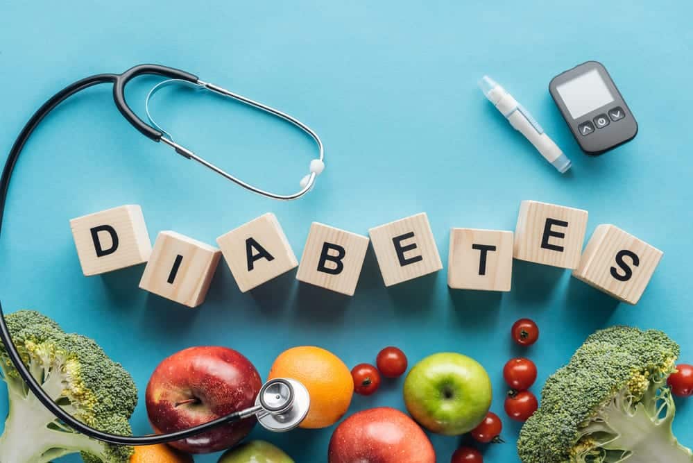 Blue-background-produce-on-bottom-blocks-spelling-out-DIABETES-stethoscope-and-blood-sugar-meter
